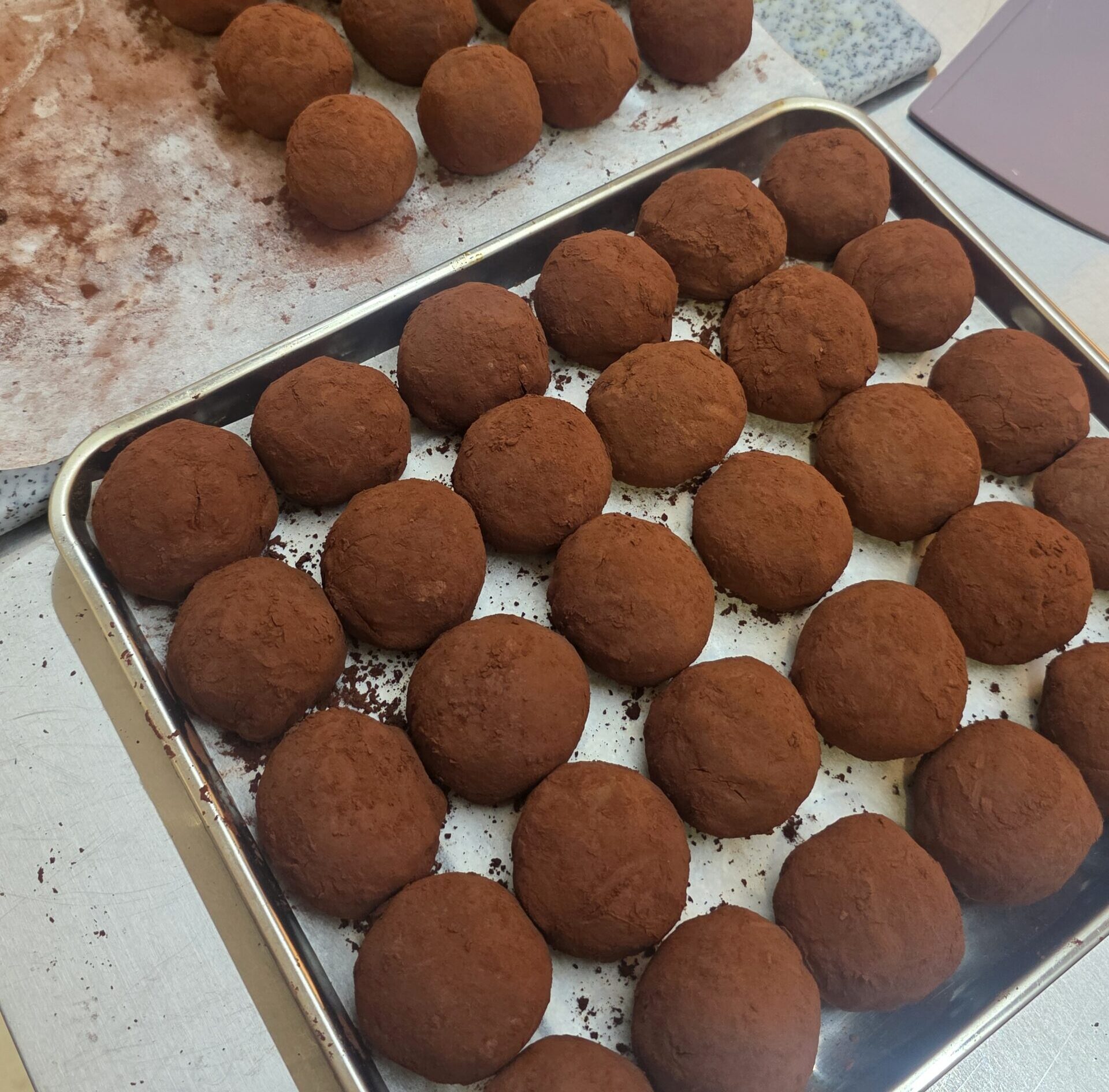 Homemade Dubai Chewy Cookies dusted with cacao powder on a tray