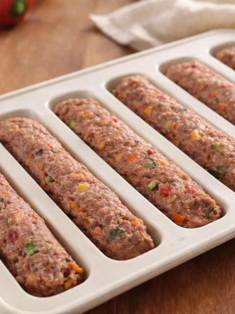 Homemade baby beef sticks with vegetables placed in a silicone mold tray for baby food preparation